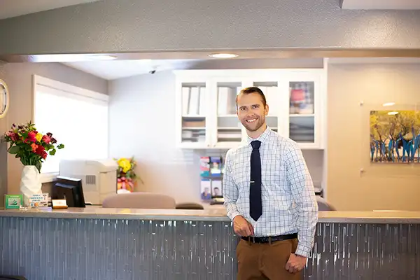 Dr. Shull standing at the reception desk area